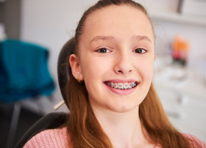 Teenager with braces smiling in the dental chair