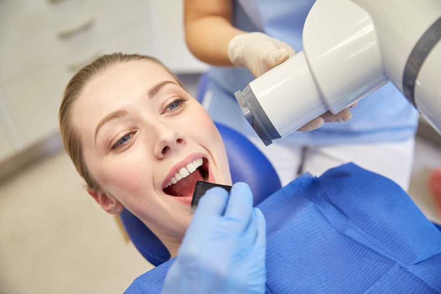 Patient having a dental X-ray taken to plan treatment